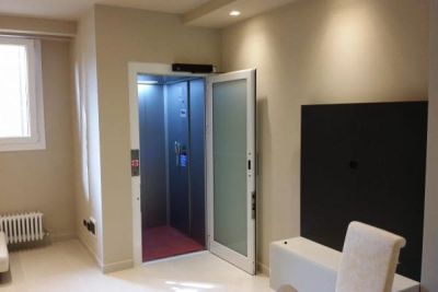Image of an home lift with the glass door open